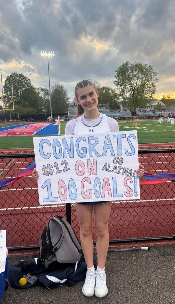 alaina donahue holds poster congratulating her on 100 career goals for binghamton girls lacrosse