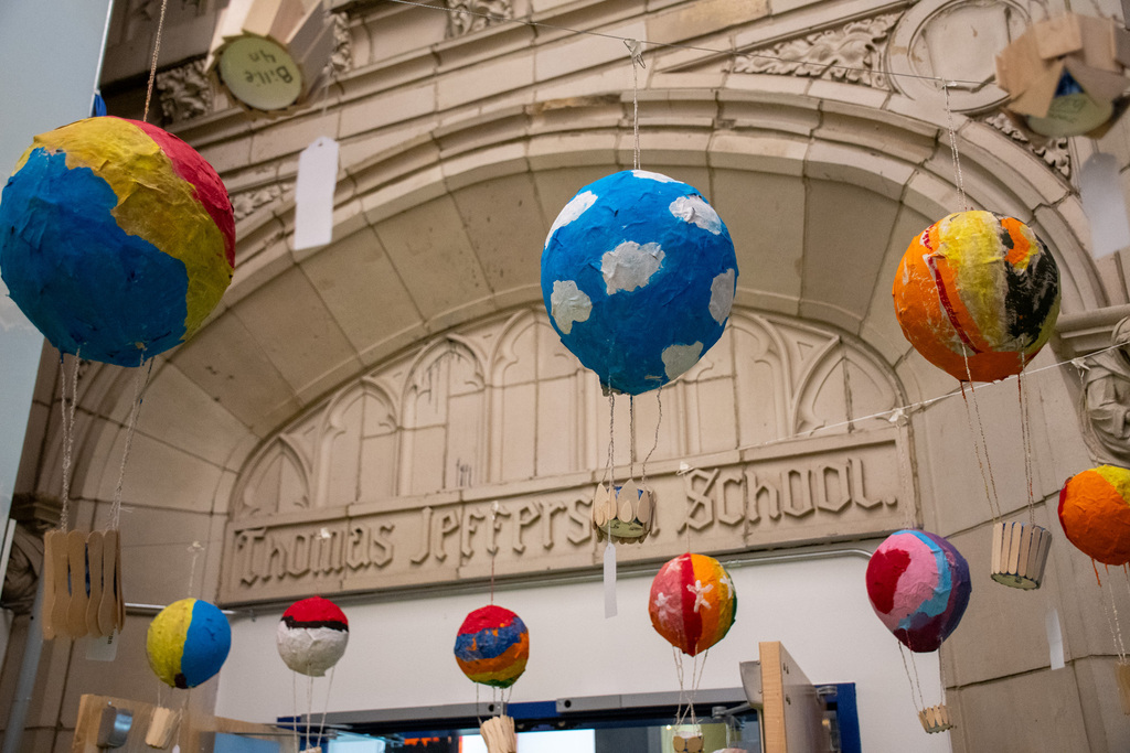paper mache hot air balloons hang from ceiling at thomas jefferson art show