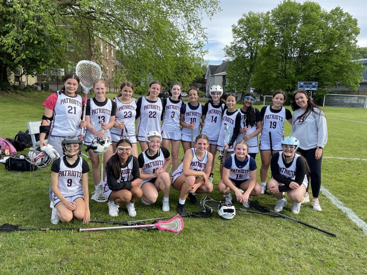 modified girls lacrosse team poses for photo on field after finishing season undefeated