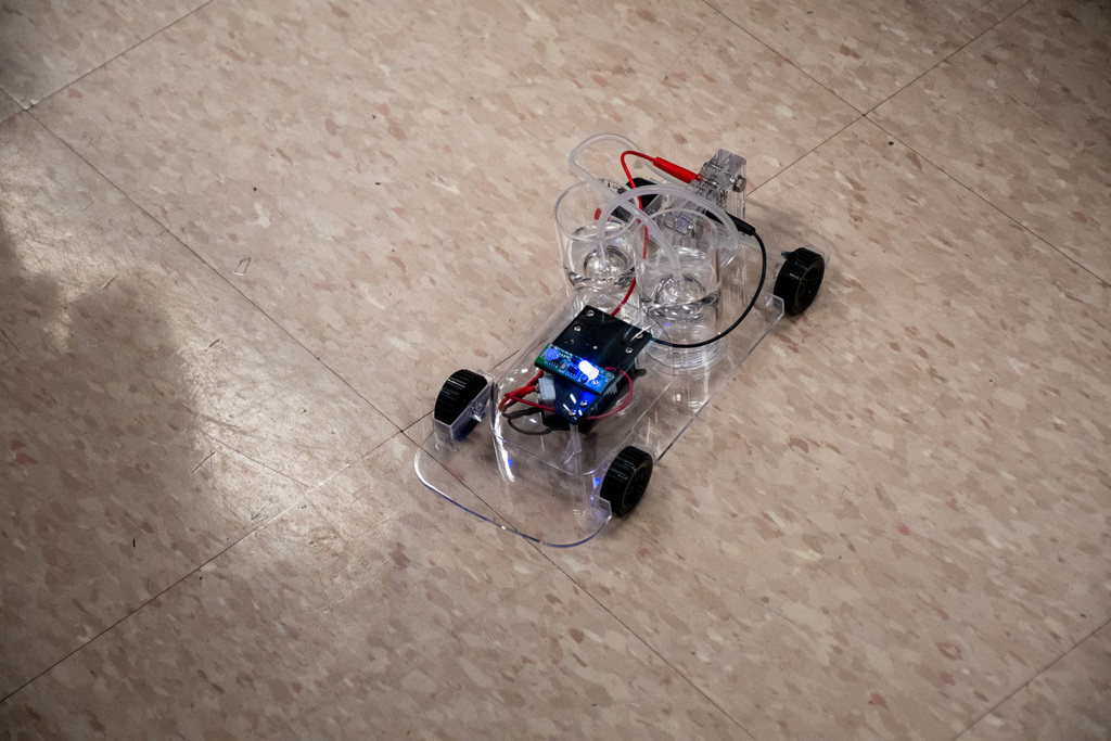 hydrogen fuel cell car drives along classroom floor
