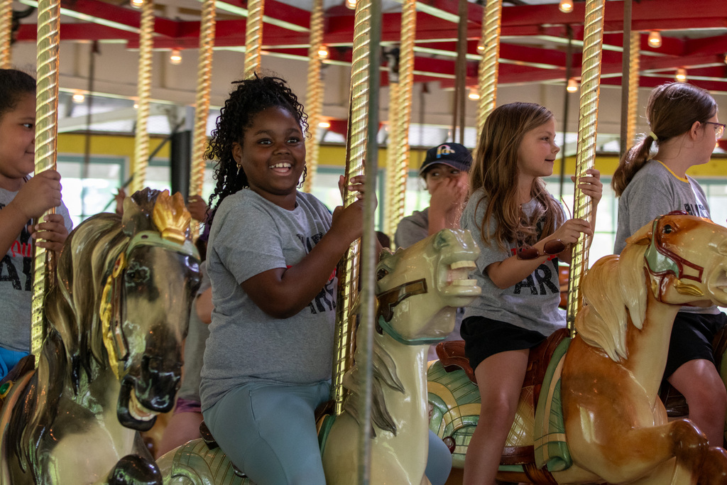 students ride carousel at recreation park