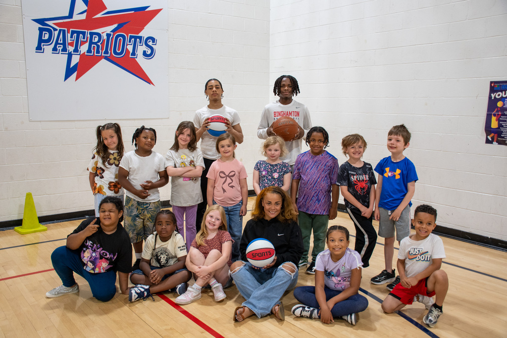 students from mrs. ryder's first grade class pose for photo with students from BHS
