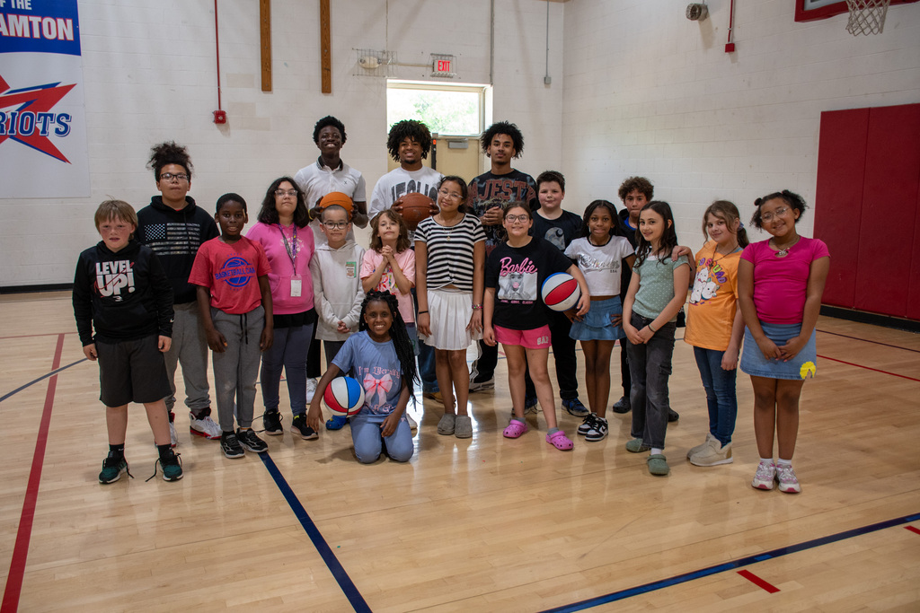 students from mrs. booth's fourth grade class at calvin coolidge pose for photo with students from BHS