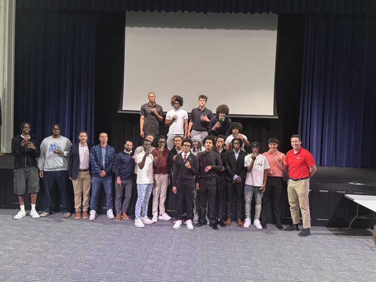 2025 state championship basketball team poses for photo in Helen Foley Theatre