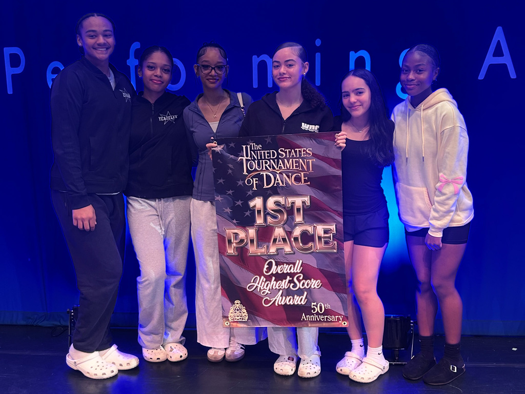 bhs dance students hold first place banner