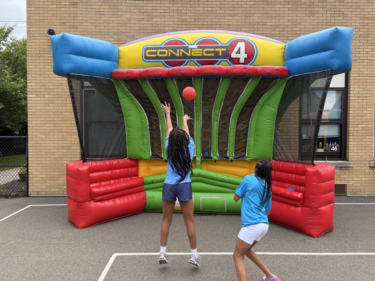 student shoots on inflatable basketball hoop