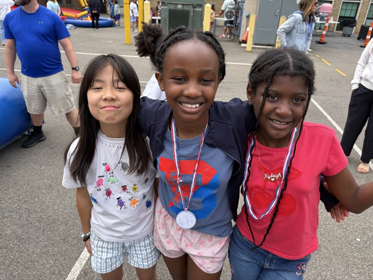 three students pose for photo at TJ Fun Day
