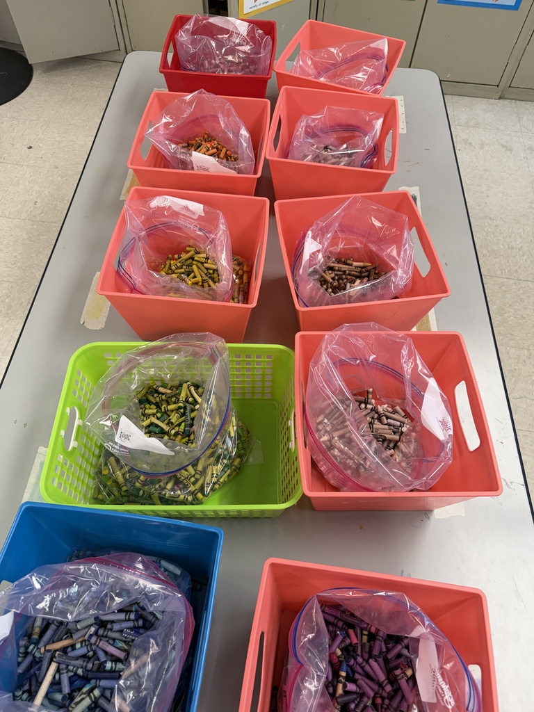 used crayons inside bins, sorted by color
