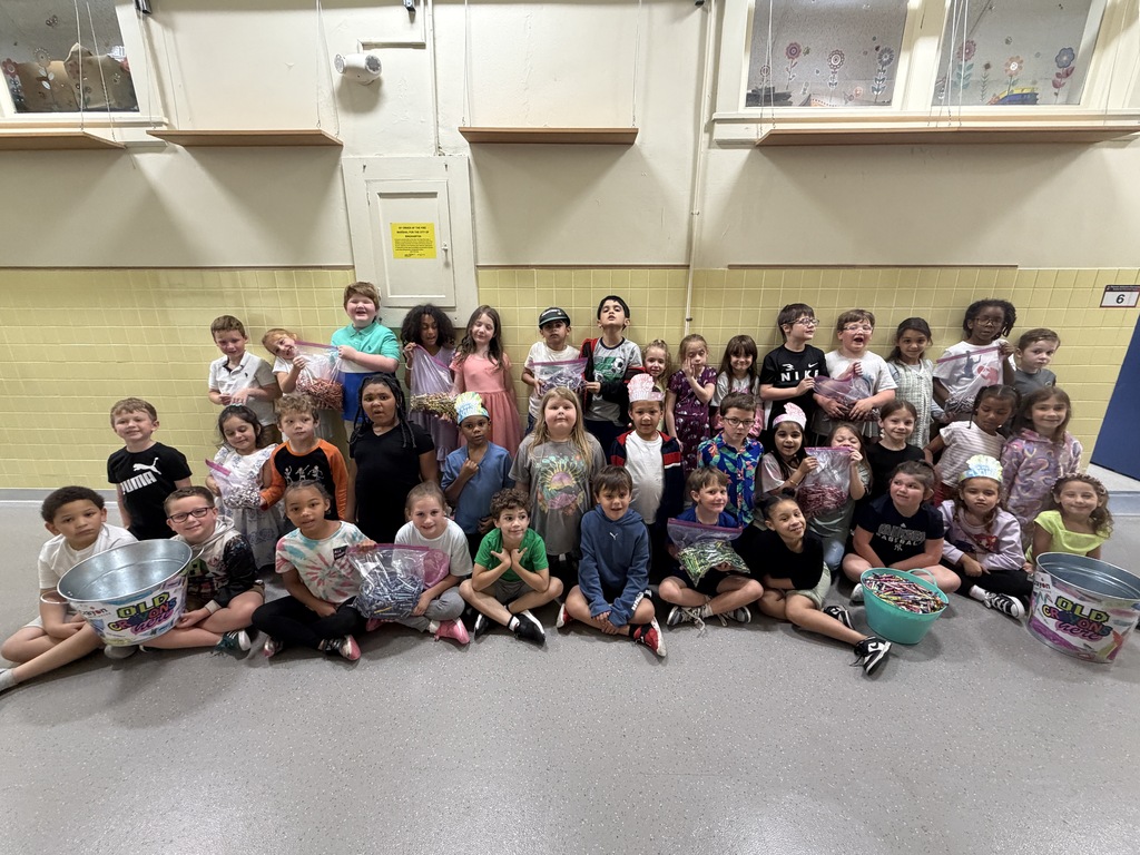 first grade students from thomas jefferson pose with crayons they collected throughout the year