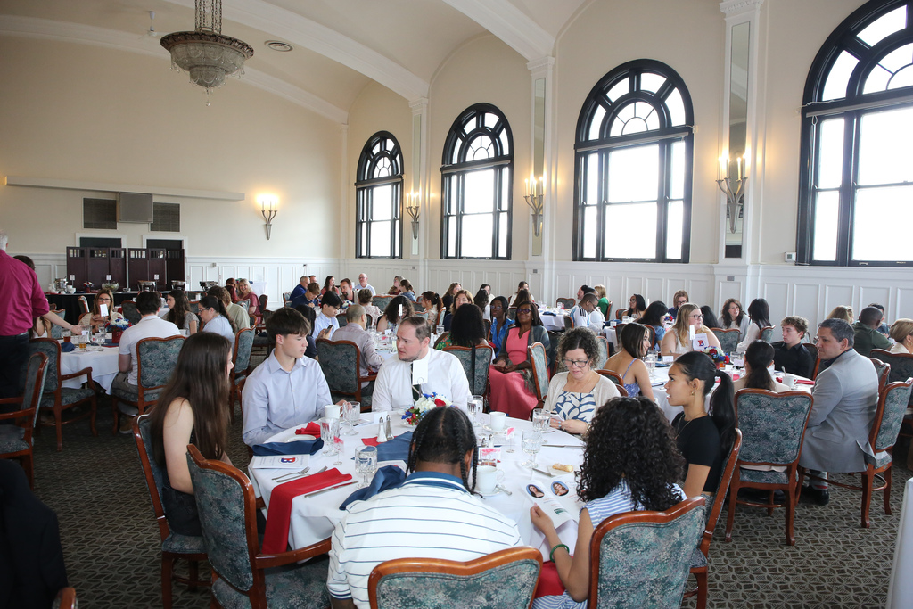 students families and staff members sit at tables during Top 25 lunch