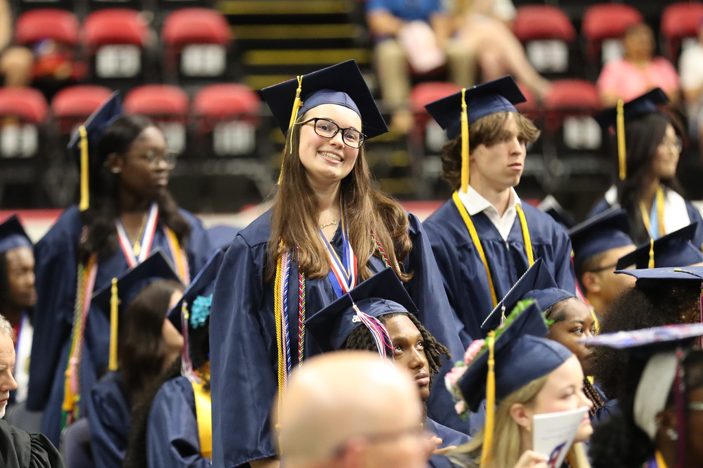 student smiles for camera during binghamton high school commencement ceremony