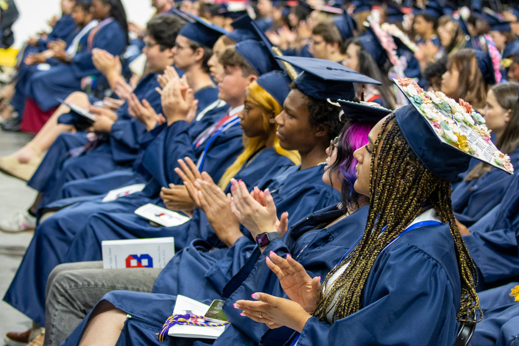 students clapping during commencement ceremony