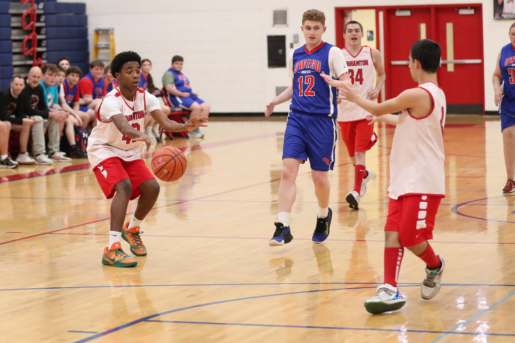 binghamton unified basketball player passes ball to teammate