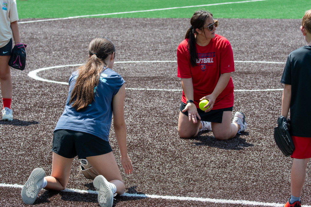coach demonstrates fielding a ground ball