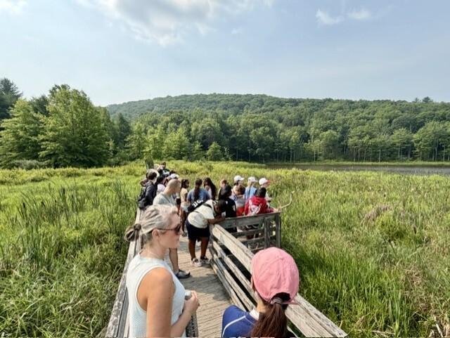 binghamton students walk through binghamton university nature preserve