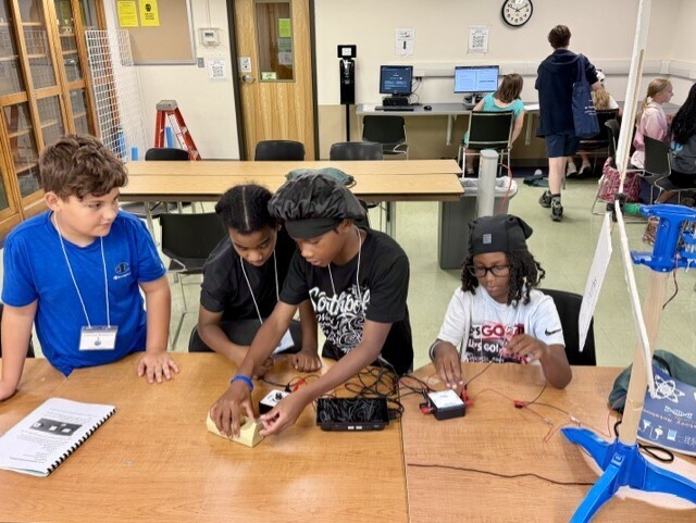 students work on science experiment