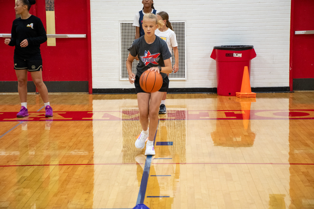 girl dribbles basketball with left hand