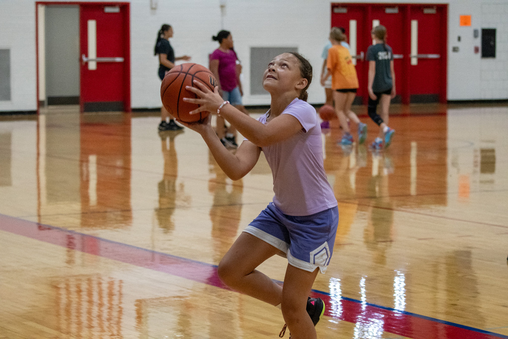 girl looks at hoop as she shoots layup