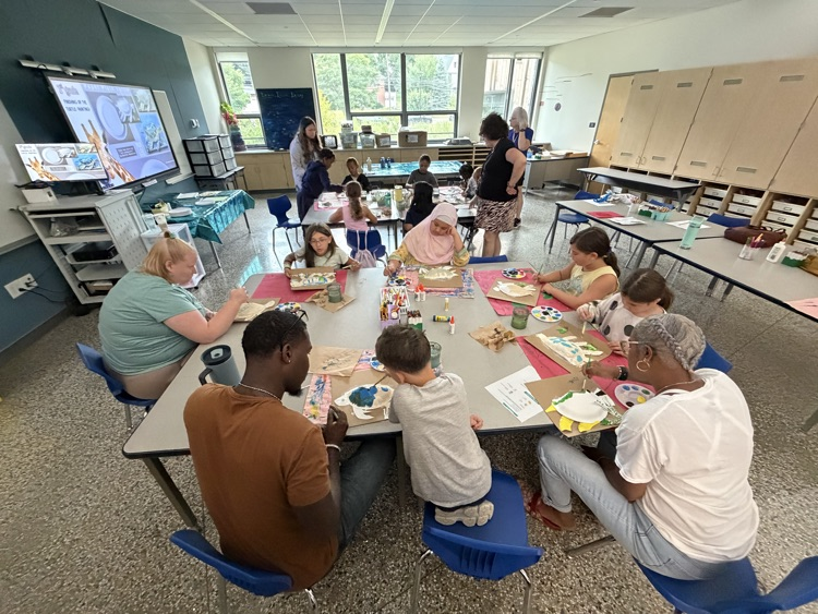 classroom of students and teachers painting sea turtle crafts
