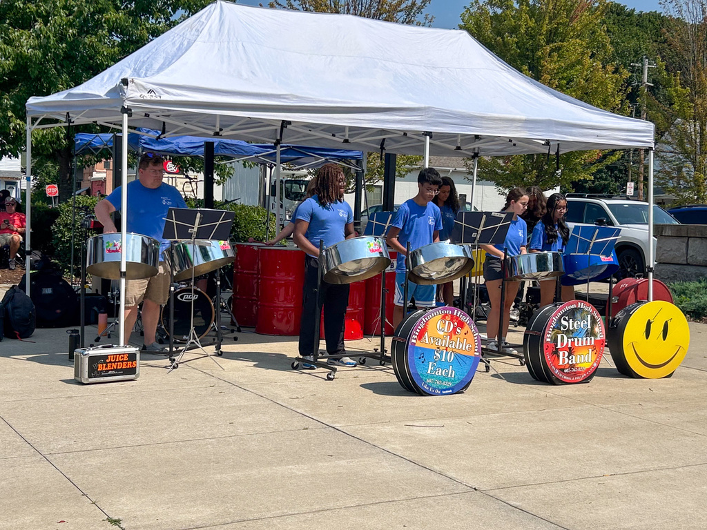 students and teacher play steel drums under tent at southside commons park