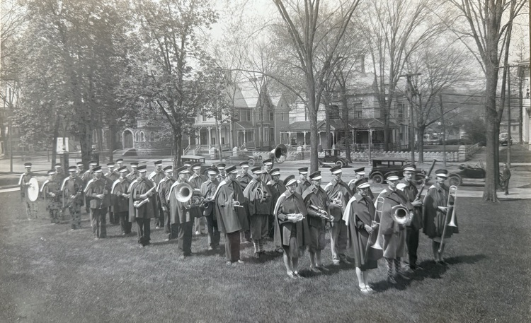 100 year-old photo of the Binghamton Central High School marching band standing on high school front lawn