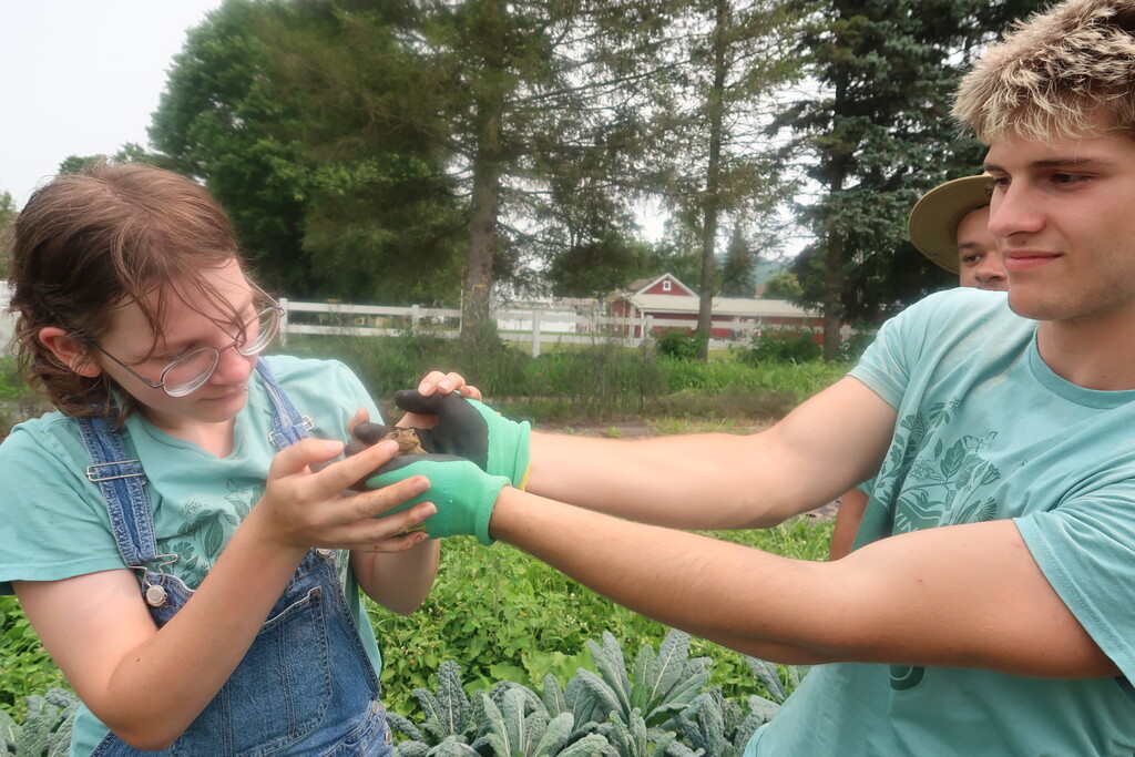 students holding frog
