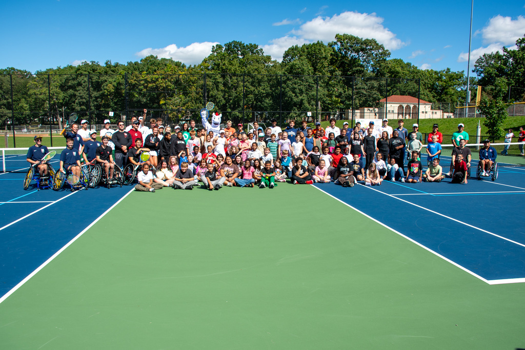 horace mann students pose for photo with college tennis players during clinic at recreation park