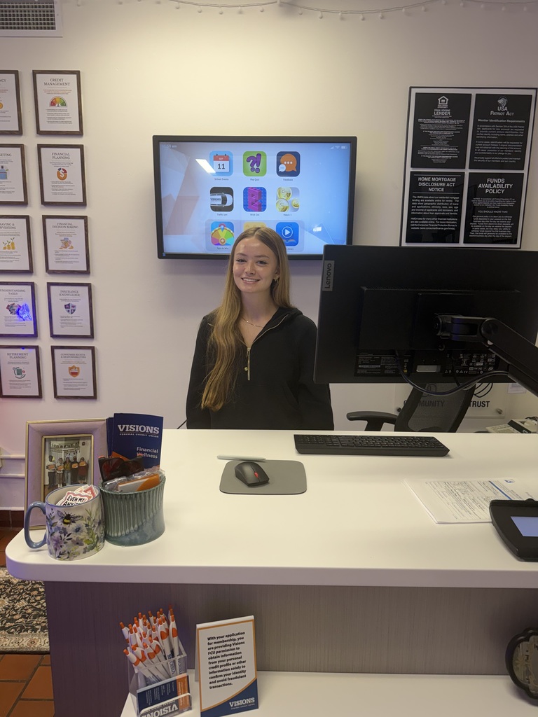 visions intern dinah sitting at teller's desk
