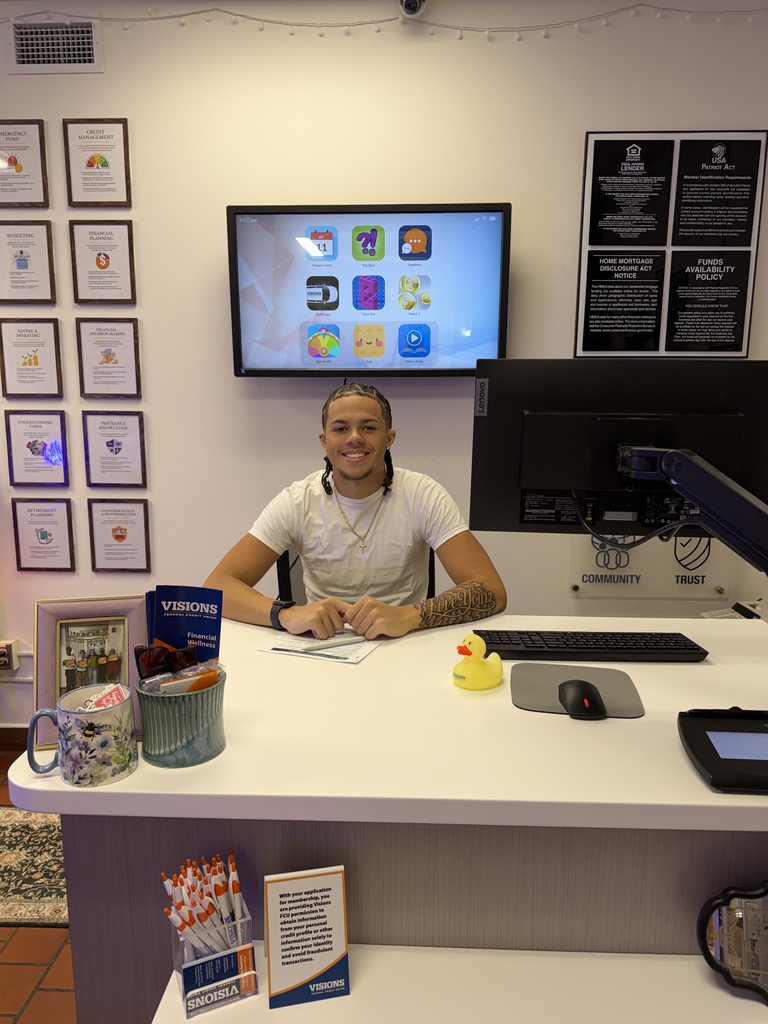 visions intern mason sitting at teller's desk