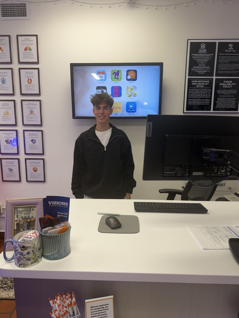visions intern carson standing at teller's desk