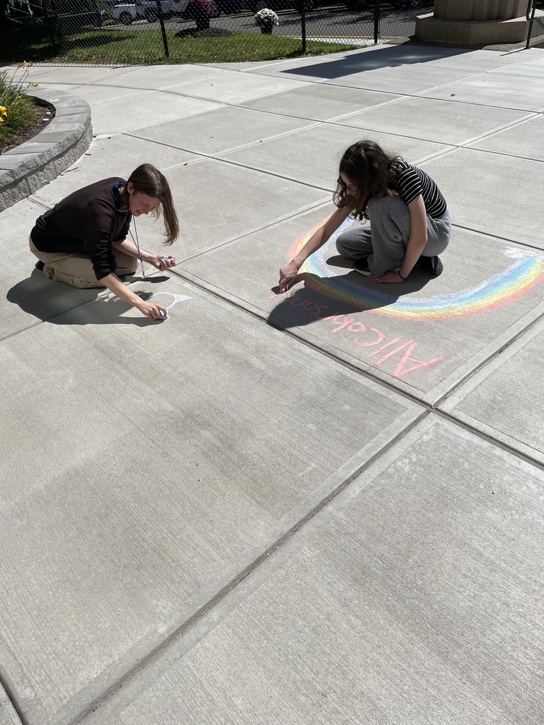 west middle students use chalk to create positive messages outside their school