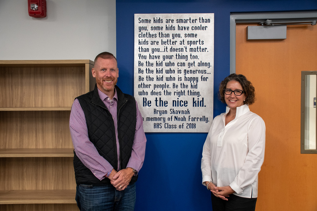 noah farrelly's parents pose with sign dedicated in their son's memory