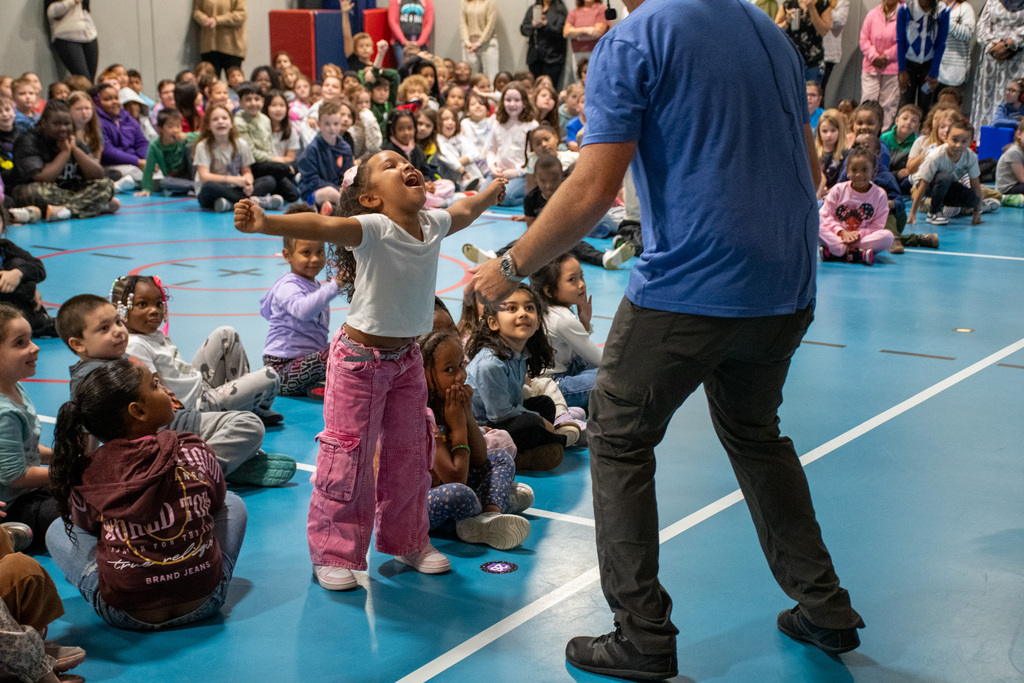 student with arms stretched out to either side