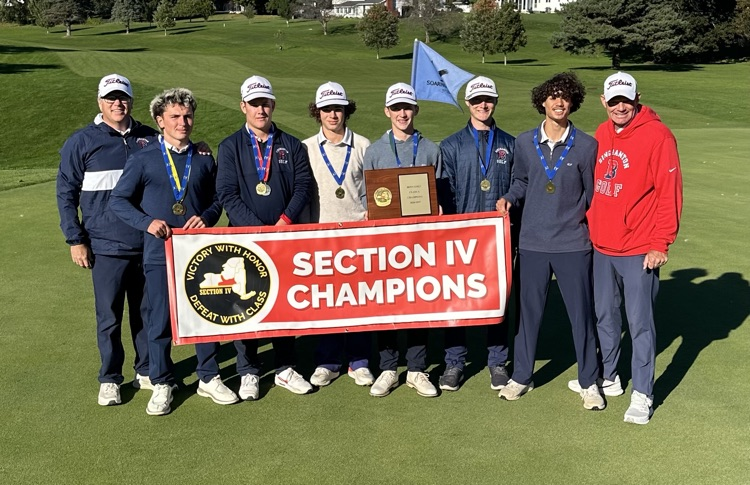 six members of BHS golf team and two coaches hold banner that says Section IV Champions