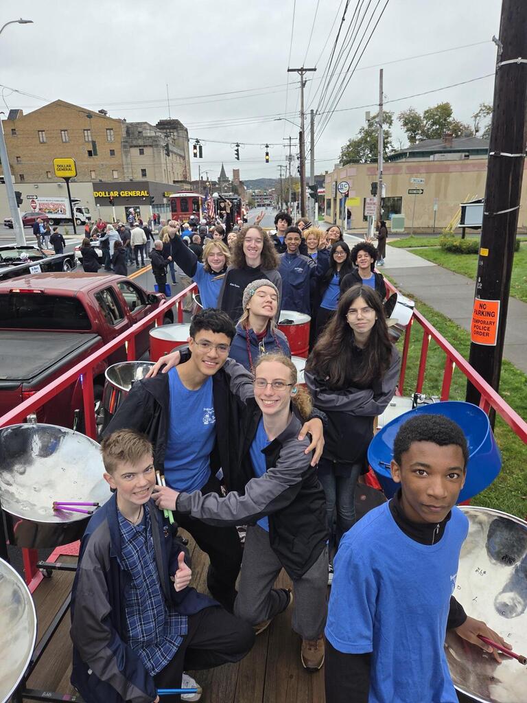 bhs steel drum band members smile for camera while standing on float prior to tournament of bands parade