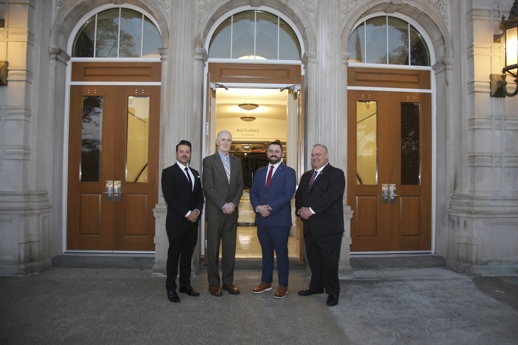 distinguished graduates pose for photo outside of binghamton high school's historic main entrance
