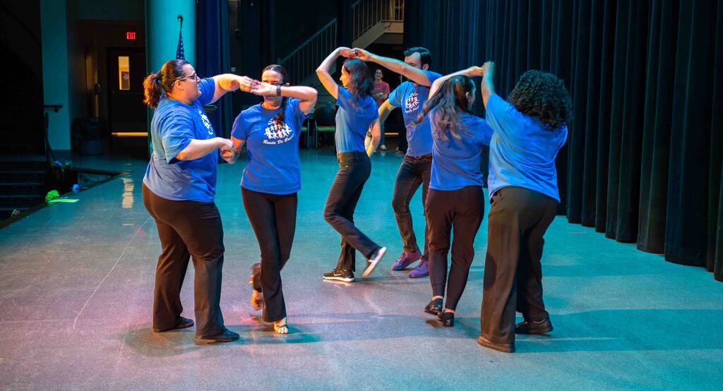 six dancers perform latin dance on stage at east middle