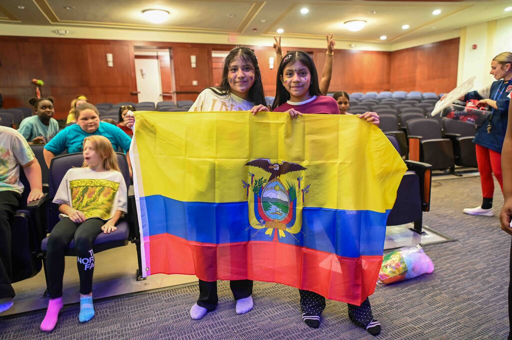 east middle students hold ecuador flag