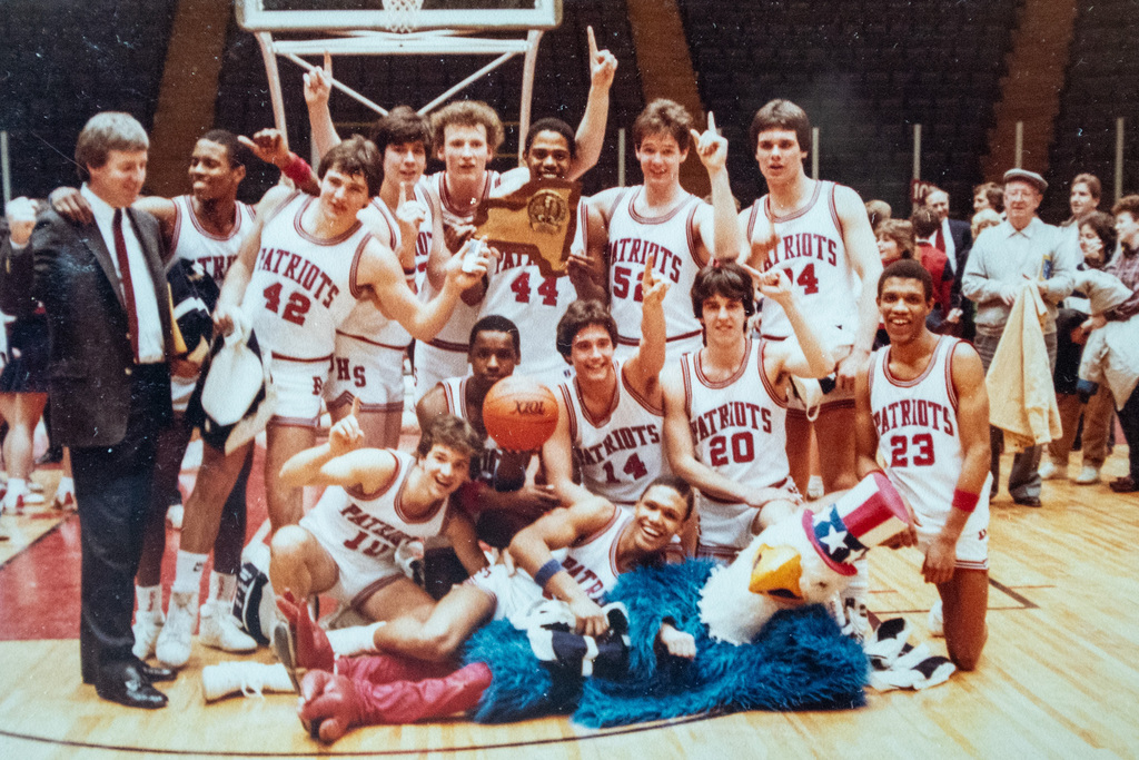 patriotic eagle mascot poses for photo with 1986 binghamton high school state championship basketball team with