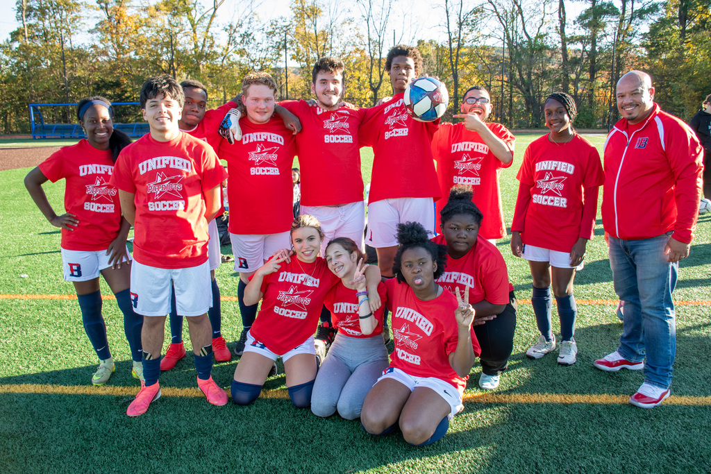 bhs unified soccer team poses for a photo on field