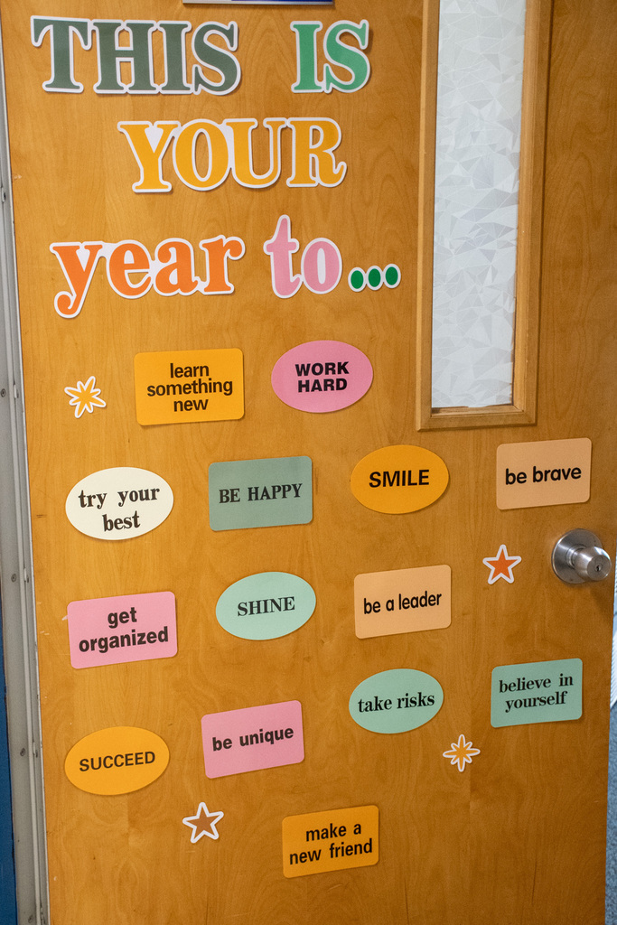 classroom door that says "this is your year to..." and smaller stickers with goals for students like "learn something new," "be brave," and "succeed"