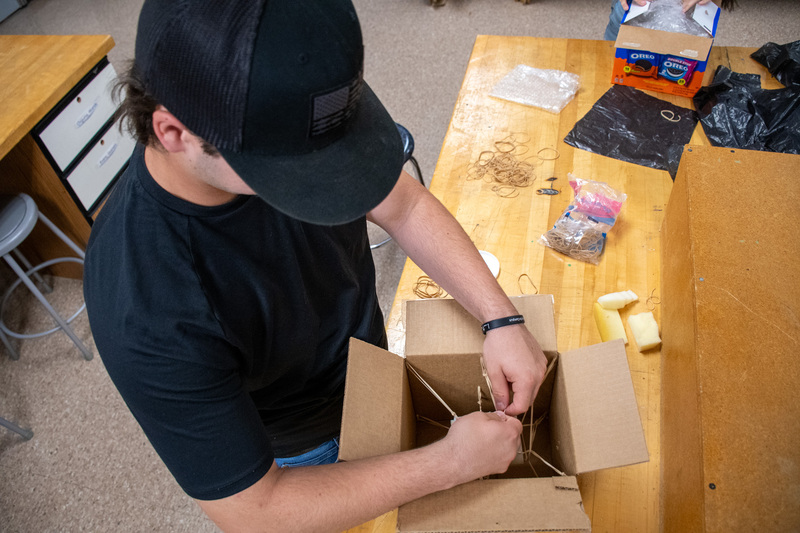 student builds egg drop container in project lead the way class