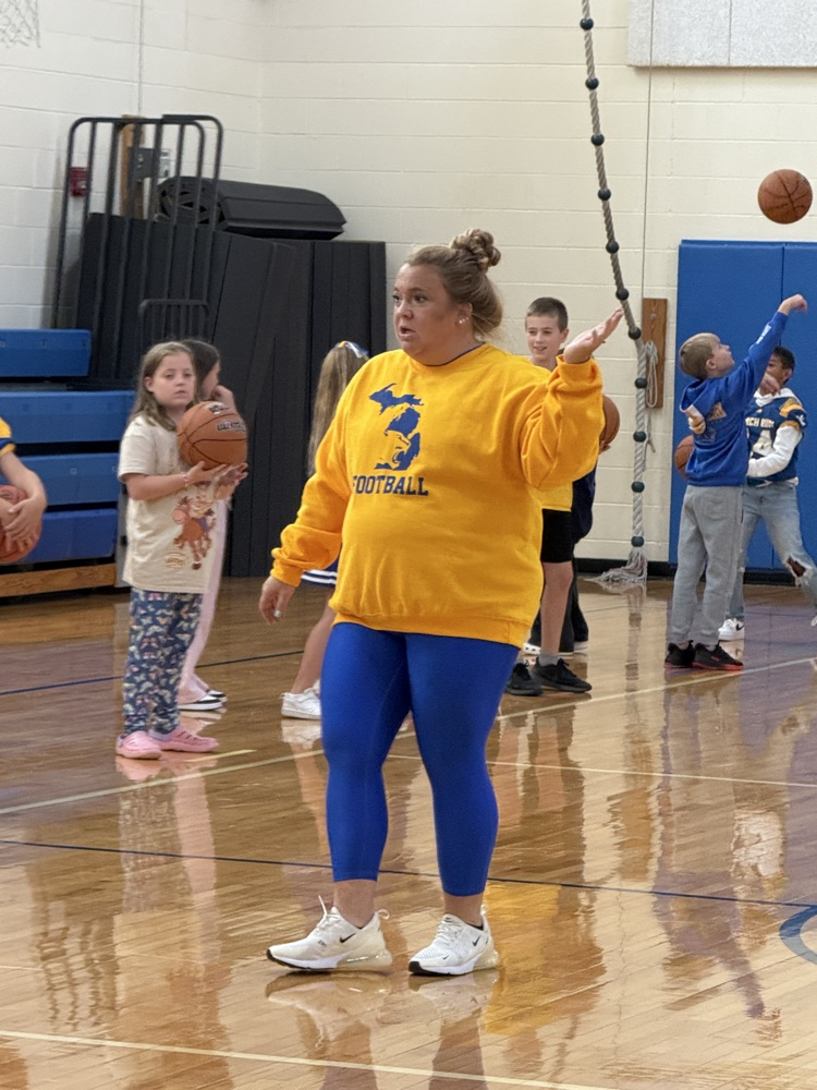 4th graders work on basketball skills in gym 