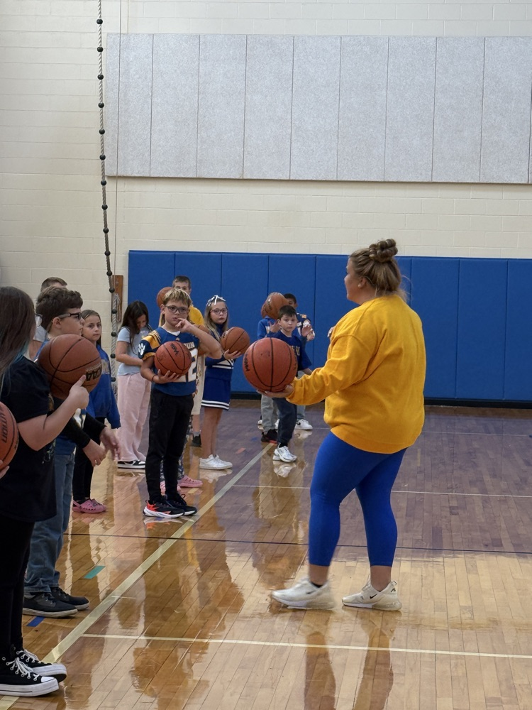 4th graders work on basketball skills in gym 