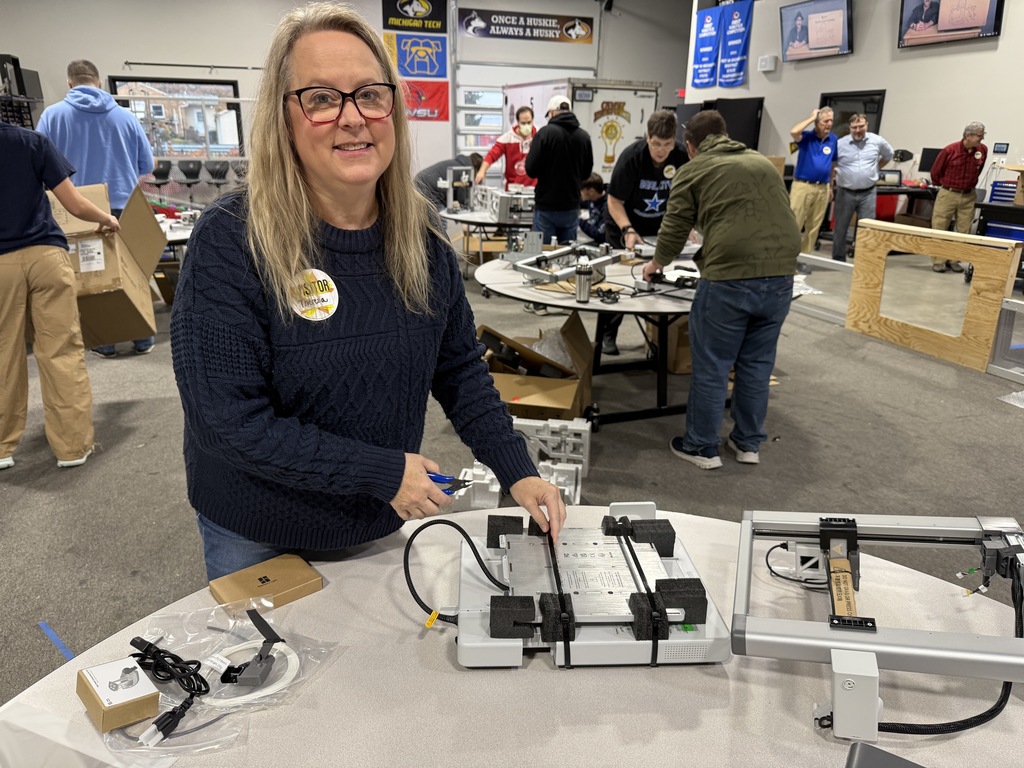 Mrs. Bomba assembles our new 3D printer.