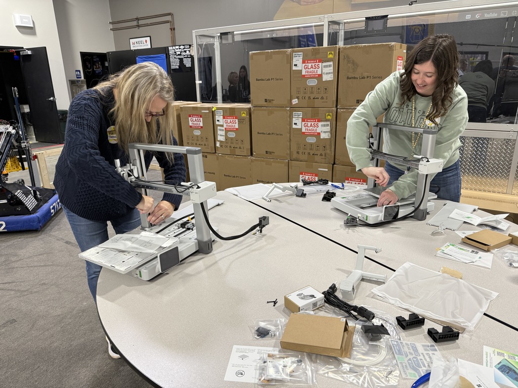 Mrs. Bomba assembles our new 3D printer.