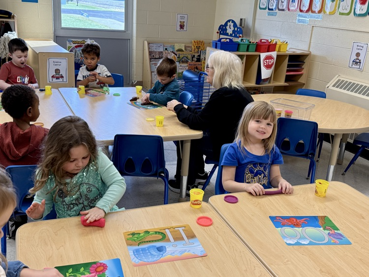 Pre-K playing with Play-Doh letter mats