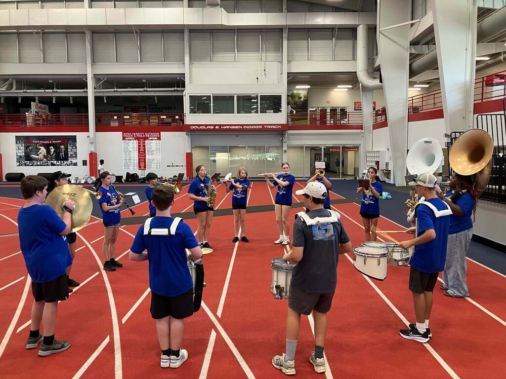 Circl of band members practicing
