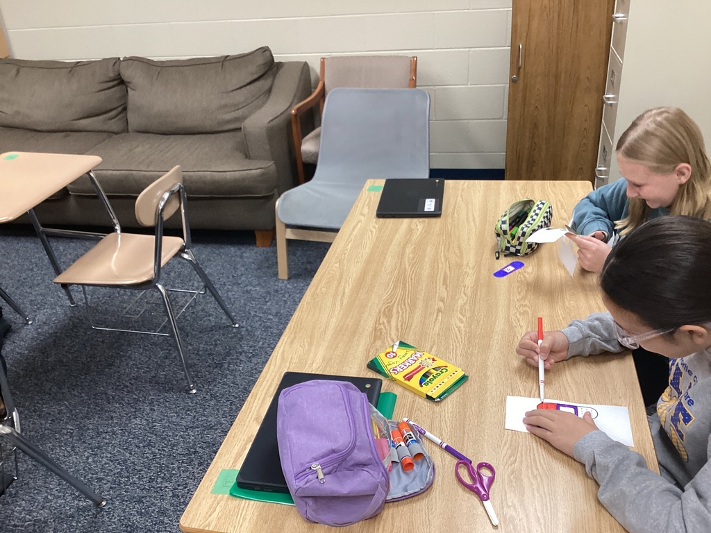 Students coloring band aids