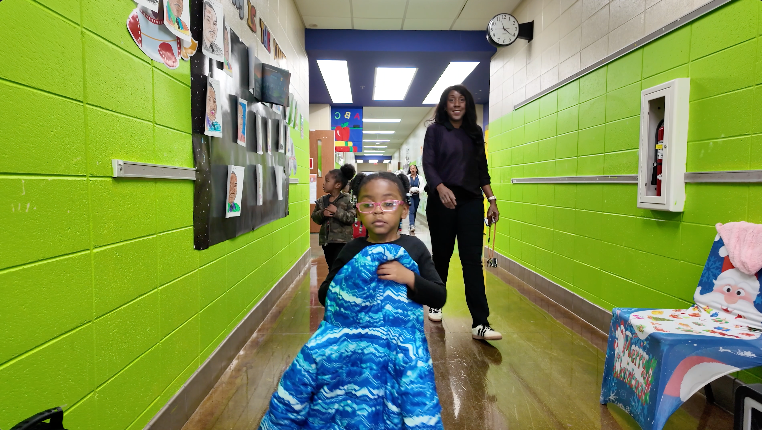 Deidre Davis walks with her pre-k students